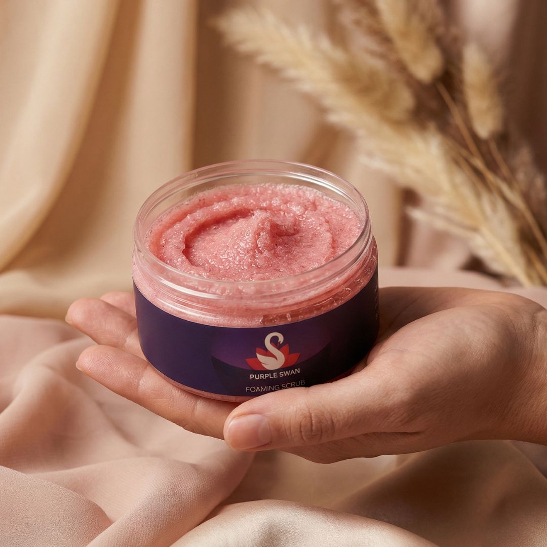 Hand holding Purple Swan foaming body scrub skincare container