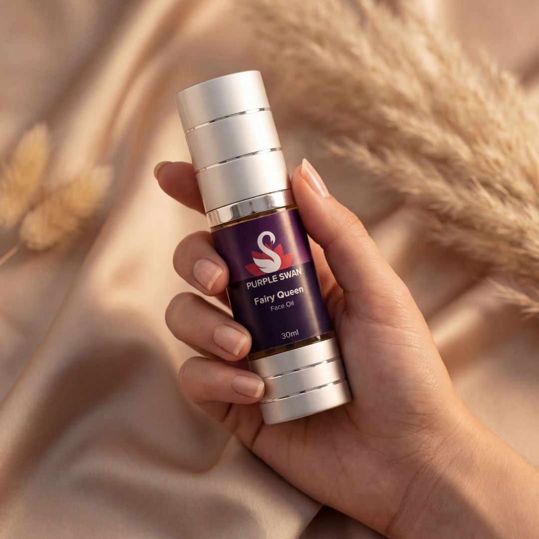 Hand holding Purple Swan Fairy Queen face oil skincare bottle