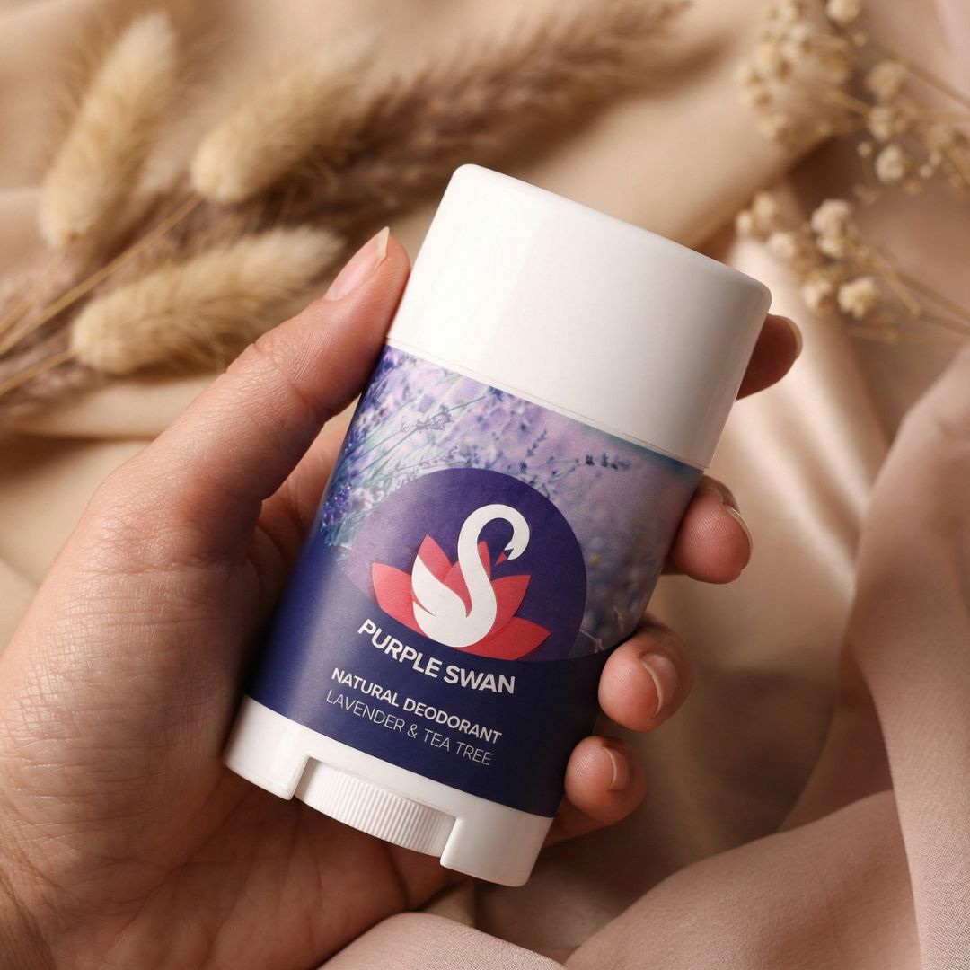 Hand holding Purple Swan lavender and tea tree natural deodorant