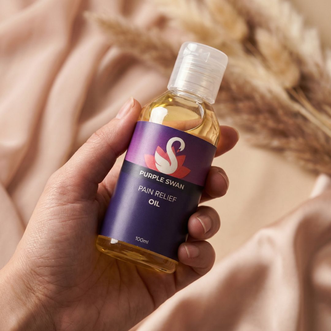 Hand Holding Purple swan Swan PAin Relif Oil bottle 