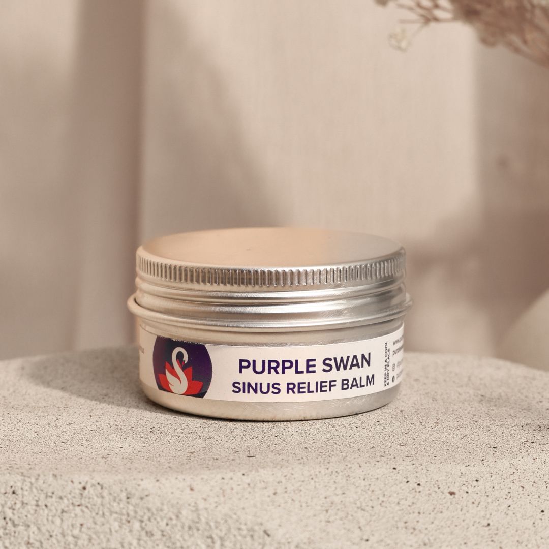 Jar of Purple Swan sinus relief balm on a textured surface with a neutral background