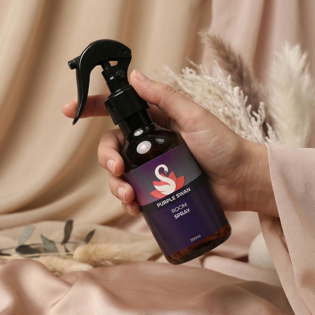 Hand Holding Purple Swan Room Spray