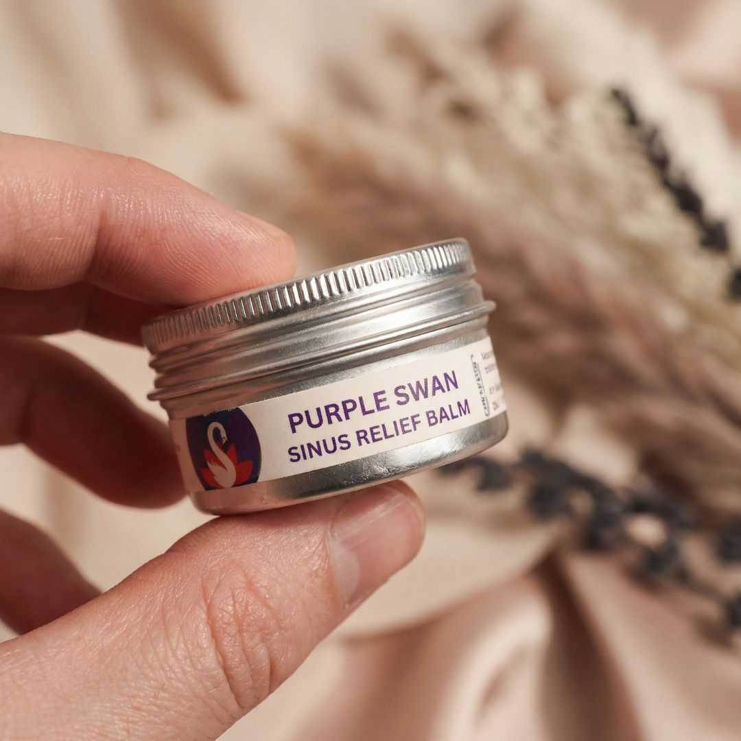 Hand Holding Purple Swan Sinus Balm